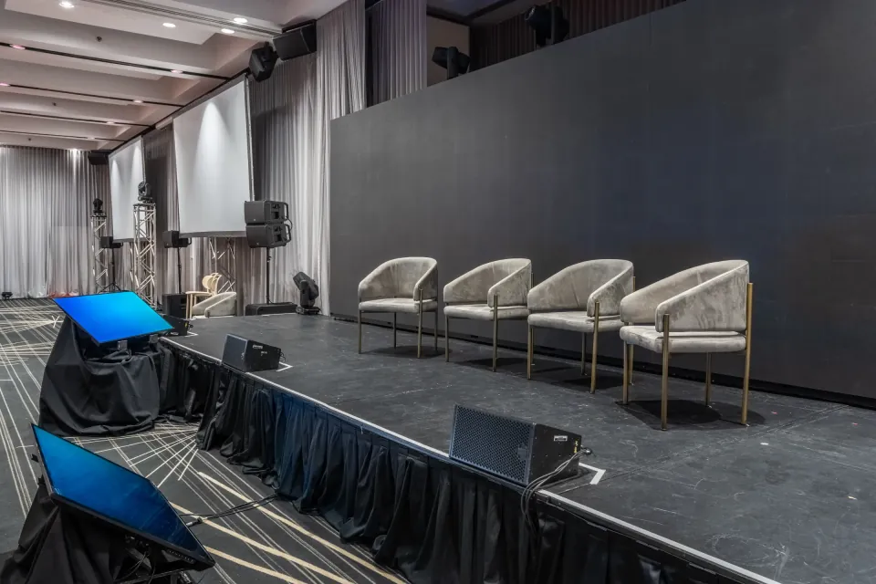 Corporate stage with armchairs and screens